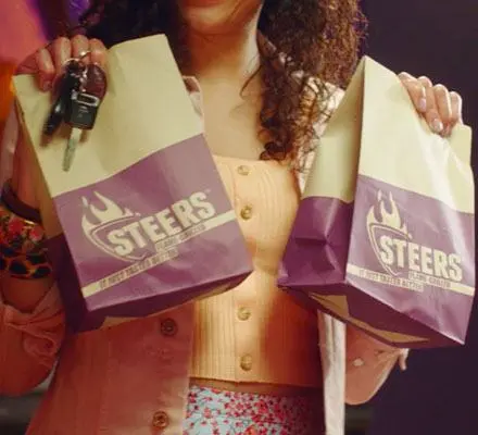 A female holding up her takeaway meals