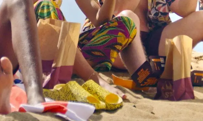 Friends enjoying burgers for lunch on the beach