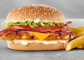 Bacon chicken cheeseburger with grilled chicken fillet, crispy bacon strips, melted cheddar cheese, lettuce, tomato, creamy mayo sauce, sesame seed bun, and chips