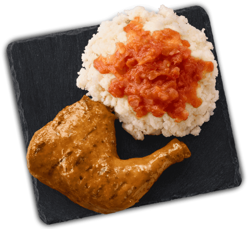 Flame grilled chicken quarter served with pap topped with sishebo on a black slate plate