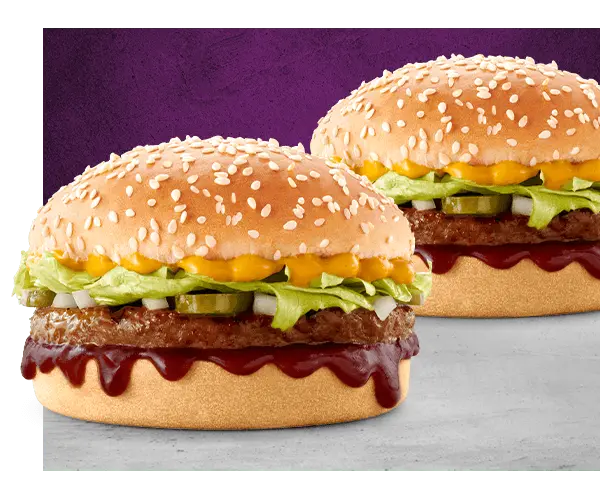 Two Wacky Wednesday burgers with beef patties, cheese, lettuce and sauce on purple background